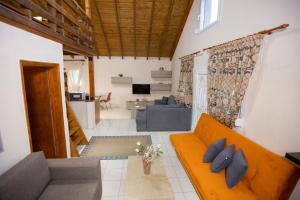 a living room with a couch and a living room at vila halkidiki in Nea Kallikrateia