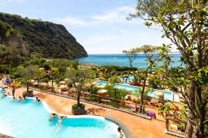 a view of the pool at a resort with the ocean at Hotel Albatros in Ischia
