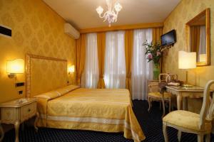 a hotel room with a bed and a table at Hotel Castello in Venice