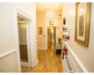 a hallway with a hallway leading to a room with at Parasol Weston Guest House in Weston-super-Mare
