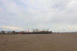 a beach with a large object on the sand at Parasol Weston Guest House in Weston-super-Mare