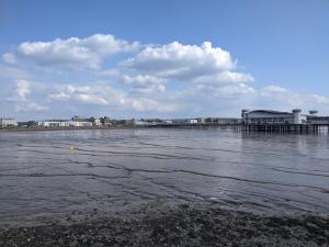 a body of water with a pier and buildings at Parasol Weston Guest House in Weston-super-Mare