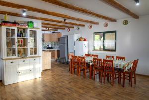 a kitchen and dining room with a table and chairs at Cununa Văilor in Deseşti