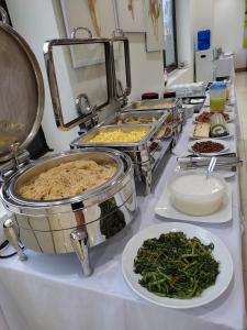 a buffet with many different dishes of food on a counter at Ocean Hotel in Xóm Tram