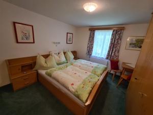 a bedroom with a large bed and a desk at Ferienhaus Laimerbauer in Faistenau