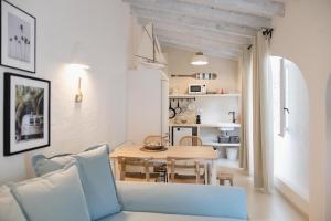 a living room with a table and a blue couch at Quinta la Sal in Jávea
