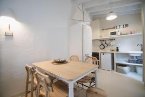 a kitchen and dining room with a table and chairs at Quinta la Sal in Jávea