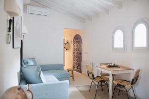 a living room with a blue couch and a table at Quinta la Sal in Jávea