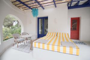 a bedroom with a bed and a table and chairs at Quinta la Sal in Jávea