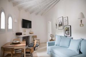 a living room with a blue couch and a table at Quinta la Sal in Jávea