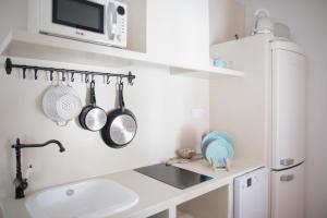 a kitchen with a sink and a microwave at Quinta la Sal in Jávea