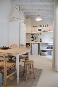 a kitchen and dining room with a table and chairs at Quinta la Sal in Jávea