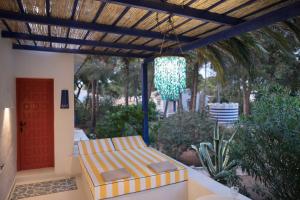a patio with a bench under a pergola at Quinta la Sal in Jávea