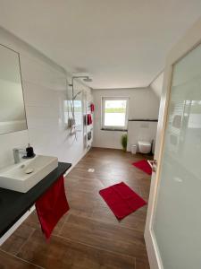 a bathroom with a white sink and a toilet at Ferienwohnung Dörrwies in Sankt Wendel +16 photos