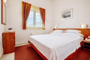 Postel nebo postele na pokoji v ubytování Hotel Posejdon