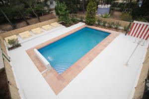 an overhead view of a swimming pool with chairs and a flag at Quinta la Sal in Jávea
