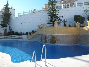 a swimming pool in front of a building at Playa Golf Apartamentos con Piscina in Benalmádena
