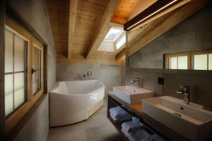 a bathroom with a tub and a sink and a tub at Bodehüttli in Adelboden