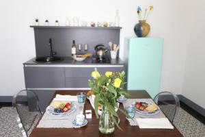 a table with plates of food on it in a kitchen at Palazzo d'Autore - Luxury Home - Ragusa Centro in Ragusa