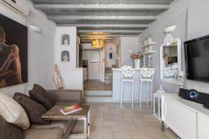 a living room with a couch and a bar at Ornos Beach House in Ornos