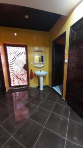 a bathroom with a sink and a microwave on the wall at TOP Appartement in Aourir