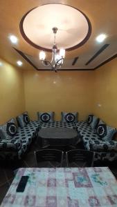 a living room with a couch and a ceiling at TOP Appartement in Aourir