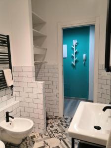 a bathroom with a white sink and a toilet at CasAgnese Sanremo in Sanremo +27 photos