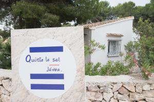 a sign in front of a building with a house at Quinta la Sal in Jávea