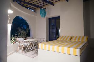 a bedroom with a bed and a table on a balcony at Quinta la Sal in Jávea
