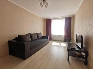 a living room with a couch and a table at Kakadu apartments in Sumy