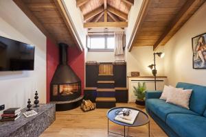 a living room with a blue couch and a fireplace at IALNA Boutique Hotel in Ioannina