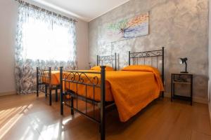 Ένα ή περισσότερα κρεβάτια σε δωμάτιο στο Qualità è Amore ROOMS