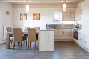 a kitchen with a table and chairs in a room at Ferienhaus - Trottellumme in Dagebüll