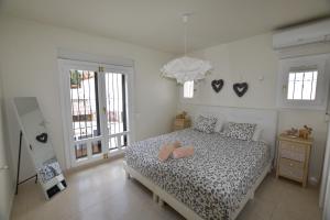 a bedroom with a bed with two pillows on it at Villa La Buena Vida in Benissa +38 photos
