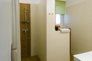 a bathroom with a shower and a sink at Toldi68 Apartmanház in Keszthely +34 photos