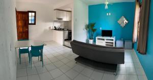 a bathroom with a tub and a table and a kitchen at Condomio Coqueiros Residence in Salvador