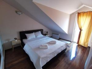 a bedroom with a bed with two towels on it at Villa Sofia in Kotor