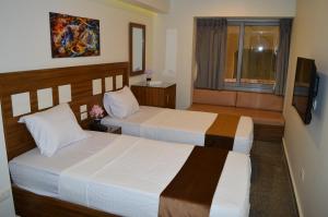 Postel nebo postele na pokoji v ubytování Royal Inn Residence