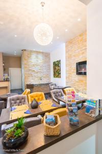 a living room with a table and couches at Hotel Villa La Tour in Nice