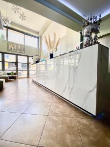 a lobby with a large white counter with a marble counter top at Mc Queen Rooms & Apartments in Athens