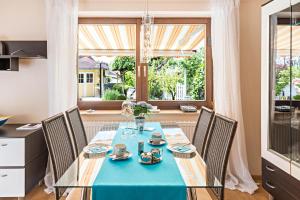 a dining room with a blue table and chairs at Ferienwohnung Wolf Überlingen in Überlingen