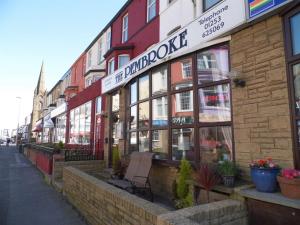 a building on a street with a bench in front of it at The Pembroke in Blackpool