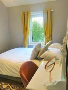 a bedroom with a bed and a window at Riverwood Cottage Stanhope in Stanhope
