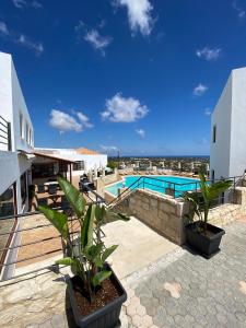a patio with a swimming pool and some plants at Amazones Village Suites in Hersonissos
