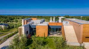 an aerial view of a building with the ocean in the background at Villa Voliera, Papafigo Camping in Vodnjan