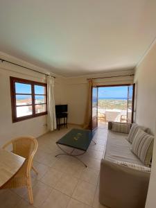 a living room with a couch and a table at Amazones Village Suites in Hersonissos
