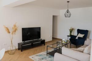 a living room with a couch and a tv at Apartment Frana in Komarna