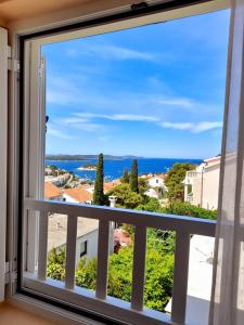 a window with a view of the ocean at Apartments and Rooms Jasna in Hvar