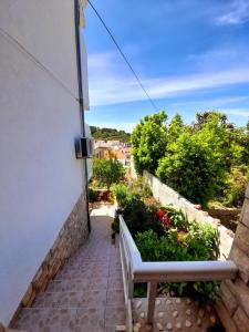 a bench sitting on a walkway next to a building at Apartments and Rooms Jasna in Hvar