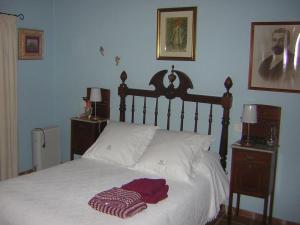 a bedroom with a bed with white sheets and two night stands at Hoya La Vieja Rural in Tejeda +25 photos